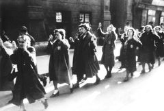 Hungary, Jewish Women with raised hands. Yellow Star of David that Jews were forced to wear during the Holocaust, specifically in Nazi-occupied countries, including Hungary. This yellow star was typically sewn onto clothing to visibly identify Jewish individuals, marking them for discrimination, persecution, and deportation. It symbolized Nazi policies of segregation and dehumanization, representing one of the tragic symbols of Jewish oppression and suffering during World War II., 1944, Miklós Szedő / Carl Lutz Foundation, [object Object], [object Object], [object Object], [object Object], [object Object], [object Object], [object Object], [object Object], [object Object], Dokuforte #4160